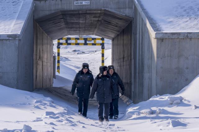 (260122) -- URUMQI, Jan. 22, 2026 (Xinhua) -- Police officers patrol in Urumqi, northwest China's Xinjiang Uygur Autonomous Region, on Jan. 19, 2026. A cold wave has swept across the region in recent days, with temperatures in parts of Altay Prefecture dropping to minus 47 degrees Celsius. Amid strong winds and snow, local authorities in charge of transport and energy sectors have coordinated their efforts to ensure uninterrupted heating service and daily supplies for the residents. (Photo by Ye Shuai/Xinhua)