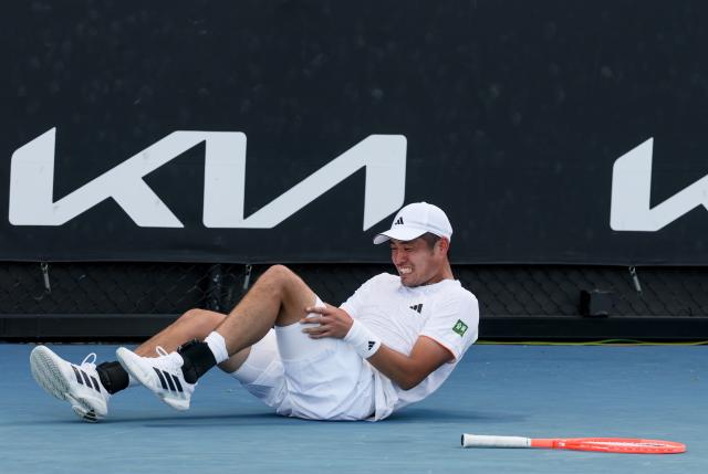 (260122) -- MELBOURNE, Jan. 22, 2026 (Xinhua) -- Wu Yibing reacts as he lies on the court during the men's singles 2nd round match between Wu Yibing of China and Eliot Spizzirri of the United States at the Australian Open tennis tournament in Melbourne, Australia, Jan. 22, 2026. (Xinhua/Ma Ping)