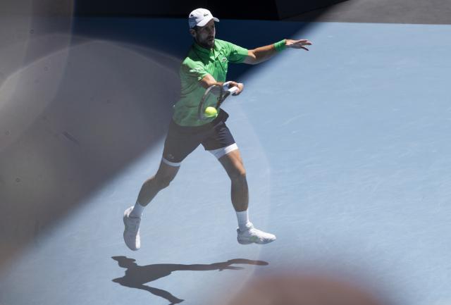 (260122) -- MELBOURNE, Jan. 22, 2026 (Xinhua) -- Novak Djokovic hits a return during the men's singles 2nd round match between Novak Djokovic of Serbia and Francesco Maestrelli of Italy at the Australian Open tennis tournament in Melbourne, Australia, Jan. 22, 2026. (Photo by Hu Jingchen/Xinhua)