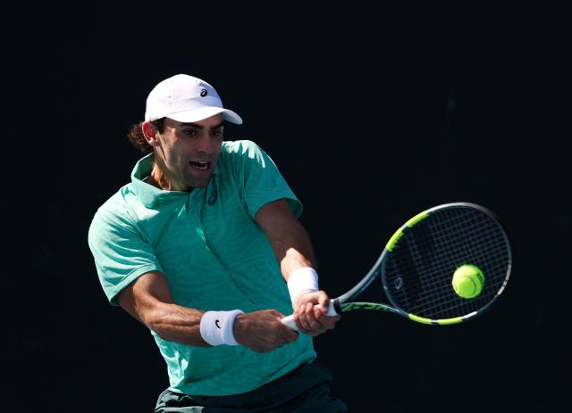 (260122) -- MELBOURNE, Jan. 22, 2026 (Xinhua) -- Eliot Spizzirri hits a return during the men's singles 2nd round match between Wu Yibing of China and Eliot Spizzirri of the United States at the Australian Open tennis tournament in Melbourne, Australia, Jan. 22, 2026. (Xinhua/Ma Ping)