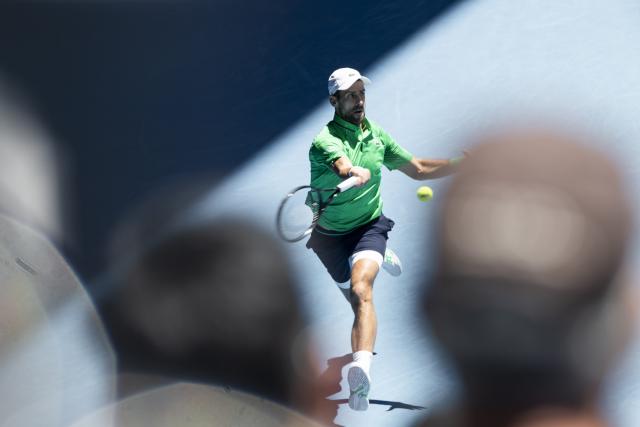 (260122) -- MELBOURNE, Jan. 22, 2026 (Xinhua) -- Novak Djokovic hits a return during the men's singles 2nd round match between Novak Djokovic of Serbia and Francesco Maestrelli of Italy at the Australian Open tennis tournament in Melbourne, Australia, Jan. 22, 2026. (Photo by Hu Jingchen/Xinhua)