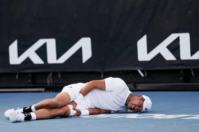 (260122) -- MELBOURNE, Jan. 22, 2026 (Xinhua) -- Wu Yibing reacts as he lies on the court during the men's singles 2nd round match between Wu Yibing of China and Eliot Spizzirri of the United States at the Australian Open tennis tournament in Melbourne, Australia, Jan. 22, 2026. (Xinhua/Ma Ping)