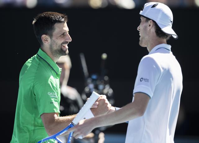 (260122) -- MELBOURNE, Jan. 22, 2026 (Xinhua) -- Novak Djokovic (L) of Serbia and Francesco Maestrelli of Italy shake hands after the men's singles 2nd round match at the Australian Open tennis tournament in Melbourne, Australia, Jan. 22, 2026. (Photo by Hu Jingchen/Xinhua)