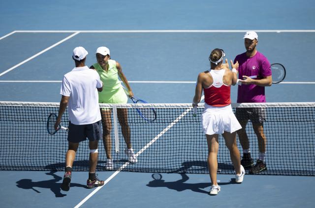 (260122) -- MELBOURNE, Jan. 22, 2026 (Xinhua) -- China's Zhang Shuai (2nd L)/Germany's Tim Puetz (1st R) and Nicole Melichar-Martinez of the United States/India's Yuki Bhambri (1st L) shake hands after their mixed doubles 1st round match at the Australian Open tennis tournament in Melbourne, Australia, Jan. 22, 2026. (Photo by Hu Jingchen/Xinhua)