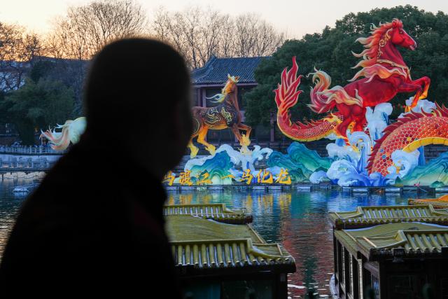 (260122) -- NANJING, Jan. 22, 2026 (Xinhua) -- Lu Min looks at the light installation work during the 40th Qinhuai Lantern Festival at the Bailuzhou Park in Nanjing, east China's Jiangsu Province, Jan. 21, 2026. Lu Min, 58, was born in a family of lantern-making business, which originated with his great-grandfather Lu Shirong. The junior Lu started to learn this craft from his father when he was 8. 
   The past decades saw Lu's career life closely connected with the development of the Qinhuai Lantern Festival. He has witnessed the gradual evolution of this traditional custom from a local event into a grand celebration. 
   In September 2020, he was officially recognized as a provincial-level inheritor of Qinhuai Lantern Festival.
  "Making a batch of lanterns each year is like seeing my children off," said Lu. Festive atmosphere are much easily felt as lanterns Lu and his coworkers have made light up the streets and lanes in the time-honored city of Nanjing. (Xinhua/Li Bo)