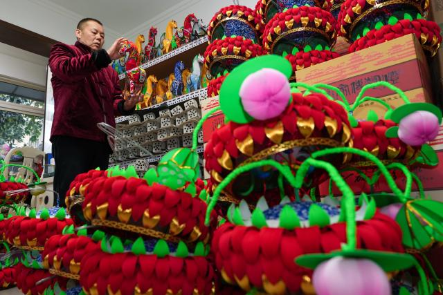 (260122) -- NANJING, Jan. 22, 2026 (Xinhua) -- Lu Min arranges lanterns themed the Year of the Horse at his studio in Nanjing, east China's Jiangsu Province, Jan. 21, 2026. Lu Min, 58, was born in a family of lantern-making business, which originated with his great-grandfather Lu Shirong. The junior Lu started to learn this craft from his father when he was 8. 
   The past decades saw Lu's career life closely connected with the development of the Qinhuai Lantern Festival. He has witnessed the gradual evolution of this traditional custom from a local event into a grand celebration. 
   In September 2020, he was officially recognized as a provincial-level inheritor of Qinhuai Lantern Festival.
  "Making a batch of lanterns each year is like seeing my children off," said Lu. Festive atmosphere are much easily felt as lanterns Lu and his coworkers have made light up the streets and lanes in the time-honored city of Nanjing. (Xinhua/Li Bo)