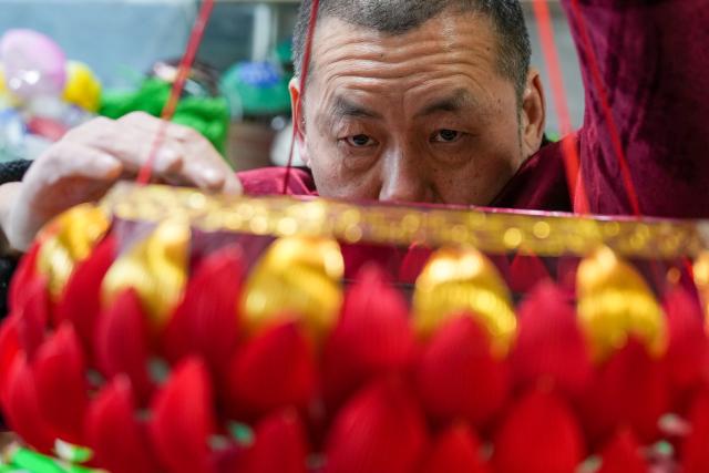 (260122) -- NANJING, Jan. 22, 2026 (Xinhua) -- Lu Min makes a lantern at his studio in Nanjing, east China's Jiangsu Province, Jan. 21, 2026. Lu Min, 58, was born in a family of lantern-making business, which originated with his great-grandfather Lu Shirong. The junior Lu started to learn this craft from his father when he was 8. 
   The past decades saw Lu's career life closely connected with the development of the Qinhuai Lantern Festival. He has witnessed the gradual evolution of this traditional custom from a local event into a grand celebration. 
   In September 2020, he was officially recognized as a provincial-level inheritor of Qinhuai Lantern Festival.
  "Making a batch of lanterns each year is like seeing my children off," said Lu. Festive atmosphere are much easily felt as lanterns Lu and his coworkers have made light up the streets and lanes in the time-honored city of Nanjing. (Xinhua/Li Bo)