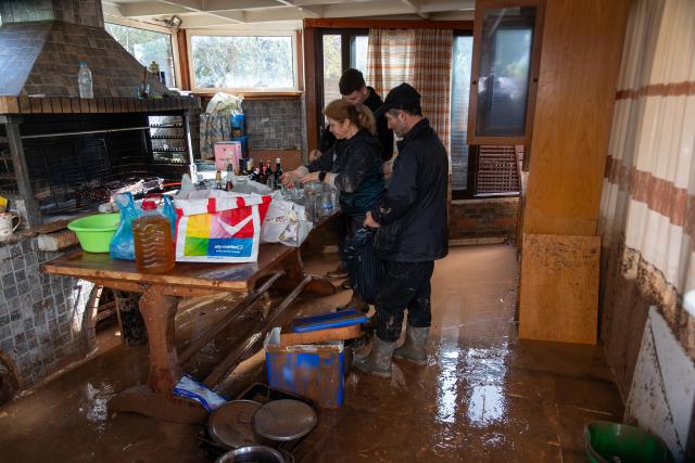 (260123) -- VARI, Jan. 23, 2026 (Xinhua) -- People clean a flooded house in Vari, southern Athens, Greece, Jan. 21, 2026. Two people were killed on Wednesday as a severe weather system swept across Greece, authorities said. (Xinhua/Marios Lolos)
