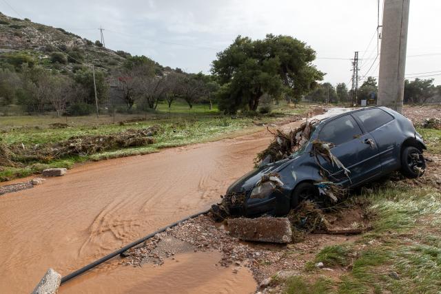 (260123) -- VARI, Jan. 23, 2026 (Xinhua) -- A car is seen damaged by flooding in Vari, southern Athens, Greece, Jan. 21, 2026. Two people were killed on Wednesday as a severe weather system swept across Greece, authorities said. (Xinhua/Marios Lolos)