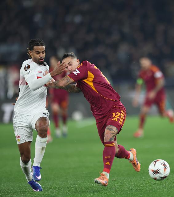 (260123) -- ROME, Jan. 23, 2026 (Xinhua) -- Roma's Kostas Tsimikas (R) vies with Stuttgart's Lorenz Assignon during the UEFA Europa League 2025/26 league phase match between Roma and Stuttgart of the UEFA Europa League in Rome, Italy, Jan. 22, 2026. (Xinhua/Li Jing)