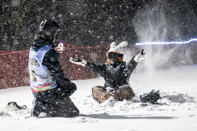 (260123) -- BEIJING, Jan. 23, 2026 (Xinhua) -- Tourists play at a ski resort in Shennongjia Forestry District, central China's Hubei Province, Jan. 19, 2026. In recent years, Hubei Province has leveraged its strategic location as a transportation hub connecting nine provinces, tapping into its unique ice and snow resources to vigorously develop the ice and snow tourism industry. Multiple locations in Hubei have become well-known ice and snow tourism destinations, attracting numerous tourists to experience the joys of winter sports. (Xinhua/Du Zixuan)