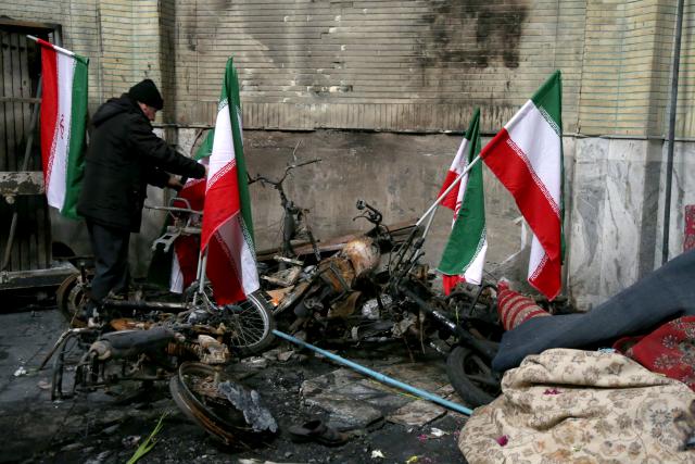 (260123) -- BEIJING, Jan. 23, 2026 (Xinhua) -- Vehicles damaged during a recent unrest are pictured in Tehran, Iran, Jan. 21, 2026. Iran's state television IRIB reported on Wednesday that 3,117 people were killed during recent unrest, citing the country's Forensic Medical Organization. (Xinhua/Shadati)