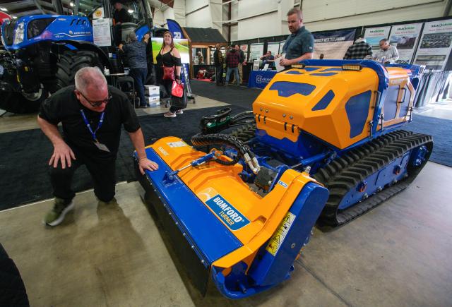 (260123) -- ABBOTSFORD, Jan. 23, 2026 (Xinhua) -- A man looks at a remote-controlled mower at the 2026 Pacific Agriculture Show in Abbotsford, British Columbia, Canada, Jan. 22, 2026. The event kicked off here on Thursday and runs until Jan. 24. (Photo by Liang Sen/Xinhua)