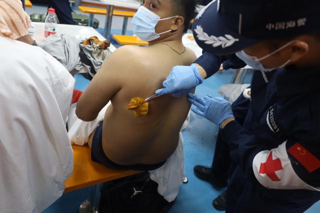 (260123) -- HUANGYAN DAO, Jan. 23, 2026 (Xinhua) -- A rescued Filipino crew member is treated by a China Coast Guard member after a foreign cargo ship capsized in the territorial waters of south China's Huangyan Dao, on Jan. 23, 2026. China Coast Guard (CCG) has saved 13 Filipino crew members from a shipwreck in the South China Sea, the CCG said on Friday.
   In the early hours of Friday, the CCG received a report that a foreign cargo ship capsized 55 nautical miles northwest of China's Huangyan Dao, with 21 Filipino crew members on board.
   Upon receiving the report, the CCG dispatched two vessels to conduct rescue operations.
   The rescue efforts are still underway, the CCG added. (China Coast Guard/Handout via Xinhua)
