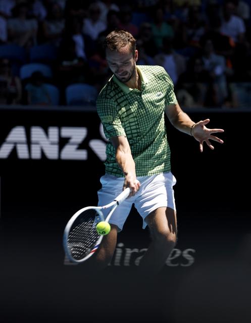 (260123) -- MELBOURNE, Jan. 23, 2026 (Xinhua) -- Daniil Medvedev of Russia hits a return during the men's singles 3rd round match against Fabian Marozsan of Hungary at the Australian Open tennis tournament in Melbourne, Australia, Jan. 23, 2026. (Xinhua/Ma Ping)