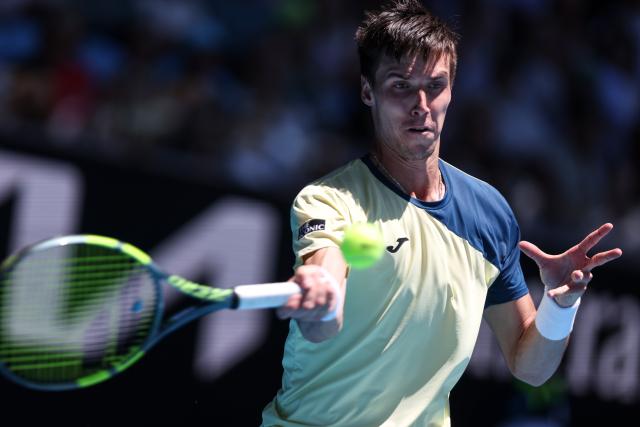 (260123) -- MELBOURNE, Jan. 23, 2026 (Xinhua) -- Fabian Marozsan of Hungary hits a return during the men's singles 3rd round match against Daniil Medvedev of Russia at the Australian Open tennis tournament in Melbourne, Australia, Jan. 23, 2026. (Xinhua/Ma Ping)