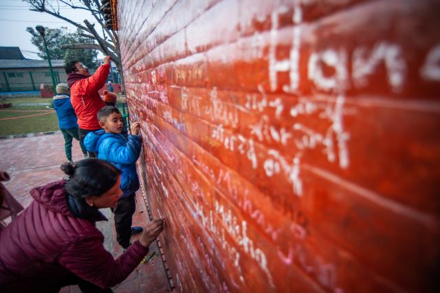 (260123) -- LALITPUR, Jan. 23, 2026 (Xinhua) -- People write their names on the wall of the temple of Goddess of Knowledge Saraswati in celebration of Basanta Panchami or Shree Panchami festival in Lalitpur, Nepal, Jan. 23, 2026. The festival is observed by worshipping Saraswati, the Hindu goddess of knowledge, wisdom, learning, art, music and culture. (Photo by Hari Maharjan/Xinhua)