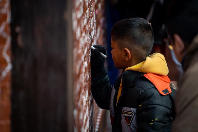 (260123) -- LALITPUR, Jan. 23, 2026 (Xinhua) -- A boy writes his name on the wall of the temple of Goddess of Knowledge Saraswati in celebration of Basanta Panchami or Shree Panchami festival in Lalitpur, Nepal, Jan. 23, 2026. The festival is observed by worshipping Saraswati, the Hindu goddess of knowledge, wisdom, learning, art, music and culture. (Photo by Hari Maharjan/Xinhua)