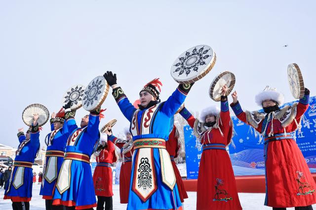 (260123) -- TONGJIANG, Jan. 23, 2026 (Xinhua) -- People of the Hezhe ethnic group stage a folk performance during a winter fishing festival in Jiejinkou Hezhe Ethnic Township, Tongjiang City, northeast China's Heilongjiang Province, on Jan. 23, 2026. The event, held on a frozen lake, is part of the province's winter fishing events. It integrates traditional Hezhe fishing and hunting culture with folk sports, offering visitors an immersive experience of the icy landscape and unique Hezhe customs. (Photo by Liu Wanping/Xinhua)