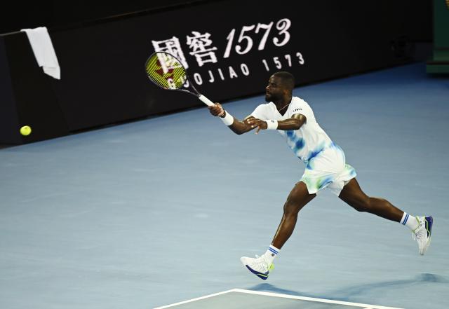 (260123) -- MELBOURNE, Jan. 23, 2026 (Xinhua) -- Frances Tiafoe hits a return during the men's singles 3rd round match between Alex de Minaur of Australia and Frances Tiafoe of the United States at the Australian Open tennis tournament in Melbourne, Australia, Jan. 23, 2026. (Photo by Wang Shen/Xinhua)