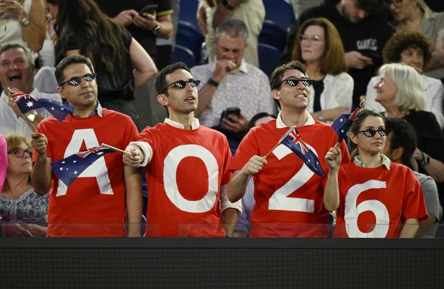 (260123) -- MELBOURNE, Jan. 23, 2026 (Xinhua) -- Spectators wave flags during the men's singles 3rd round match between Alex de Minaur of Australia and Frances Tiafoe of the United States at the Australian Open tennis tournament in Melbourne, Australia, Jan. 23, 2026. (Photo by Wang Shen/Xinhua)