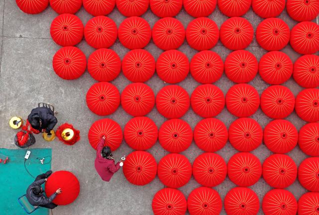 (260123) -- BEIJING, Jan. 23, 2026 (Xinhua) -- A drone photo taken on Jan. 21, 2026 shows workers making red lanterns at a lantern workshop in Hengxi Town of Taizhou City, east China's Zhejiang Province. Chinese people are busy preparing fresh flowers, Chinese knots, spring couplets, and other traditional necessities to celebrate the upcoming Spring Festival, or the Chinese New Year. (Photo by Wang Huabin/Xinhua)