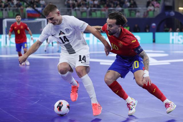 (260124) -- LJUBLJANA, Jan. 24, 2026 (Xinhua) -- Matej Fidersek (L) of Slovenia vies with Mario Rivillos of Spain during the UEFA Futsal EURO 2026 match between Slovenia and Spain at Arena Stozice, Ljubljana, Slovenia, Jan. 23, 2026. (Photo by Zeljko Stevanic/Xinhua)