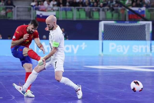 (260124) -- LJUBLJANA, Jan. 24, 2026 (Xinhua) -- Jose Raya of Spain (L) shoots to score during the UEFA Futsal EURO 2026 match between Slovenia and Spain at Arena Stozice, Ljubljana, Slovenia, Jan. 23, 2026. (Photo by Zeljko Stevanic/Xinhua)