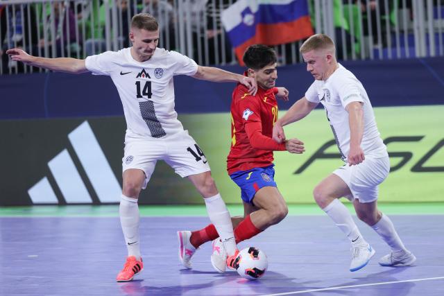 (260124) -- LJUBLJANA, Jan. 24, 2026 (Xinhua) -- David Novoa of Spain (C) competes against Matej Fidersek (L) and Teo Turk of Slovenia during the UEFA Futsal EURO 2026 match between Slovenia and Spain at Arena Stozice, Ljubljana, Slovenia, Jan. 23, 2026. (Photo by Zeljko Stevanic/Xinhua)
