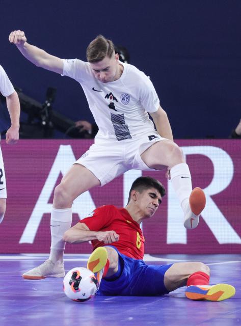 (260124) -- LJUBLJANA, Jan. 24, 2026 (Xinhua) -- Antonio Perez (bottom) of Spain vies with Jure Suban of Slovenia during the UEFA Futsal EURO 2026 match between Slovenia and Spain at Arena Stozice, Ljubljana, Slovenia, Jan. 23, 2026. (Photo by Zeljko Stevanic/Xinhua)