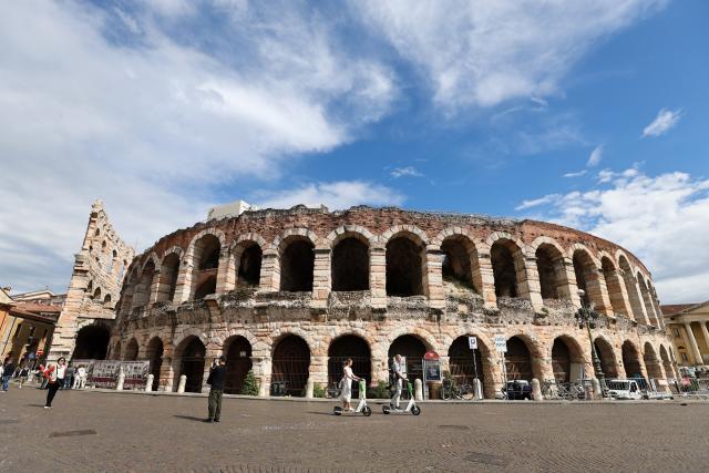 (260124) -- VERONA, Jan. 24, 2026 (Xinhua) -- People walk past the Arena di Verona in Verona, Italy, May 5, 2025. The 2026 Milan-Cortina Olympic Winter Games will run from February 6 to 22. (Xinhua/Li Jing)
