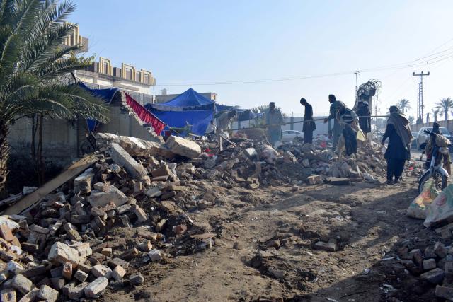 (260124) -- DERA ISMAIL KHAN, Jan. 24, 2026 (Xinhua) -- People examine a suicide blast site in Dera Ismail Khan, Khyber Pakhtunkhwa province, Pakistan, on Jan. 24, 2026. At least five people were killed and 10 others injured in a suicide blast at a wedding ceremony in Dera Ismail Khan district of Pakistan's northwest Khyber Pakhtunkhwa province on Friday, police said. No group claimed responsibility for the attack yet. (Str/Xinhua)