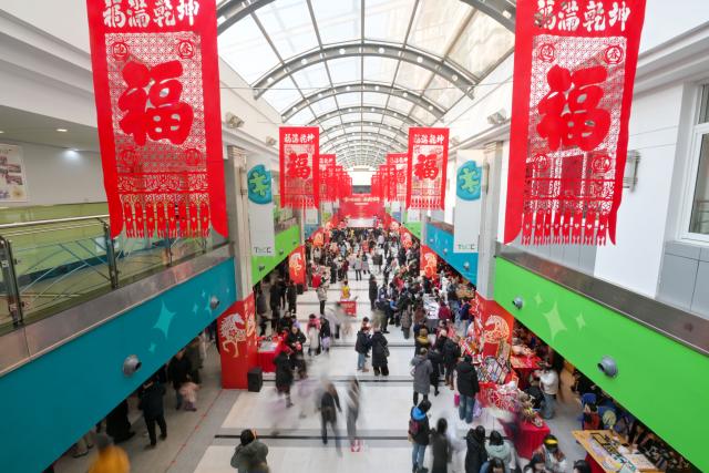 (260124) -- TIANJIN, Jan. 24, 2026 (Xinhua) -- This photo taken on Jan. 24, 2026 shows a scene of a temple fair for children in north China's Tianjin. A special temple fair tailored for children kicked off in north China's Tianjin on Saturday. Crowds of parents and kids gathered at the fair to experience the festive atmosphere ahead of the Spring Festival. The event features a variety of activities including traditional handicraft making, Tianjin-style food tasting, and interactive games. (Xinhua/Zhao Zishuo)