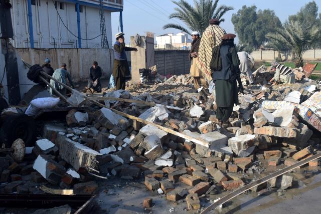 (260124) -- DERA ISMAIL KHAN, Jan. 24, 2026 (Xinhua) -- People examine a suicide blast site in Dera Ismail Khan, Khyber Pakhtunkhwa province, Pakistan, on Jan. 24, 2026. At least five people were killed and 10 others injured in a suicide blast at a wedding ceremony in Dera Ismail Khan district of Pakistan's northwest Khyber Pakhtunkhwa province on Friday, police said. No group claimed responsibility for the attack yet. (Str/Xinhua)
