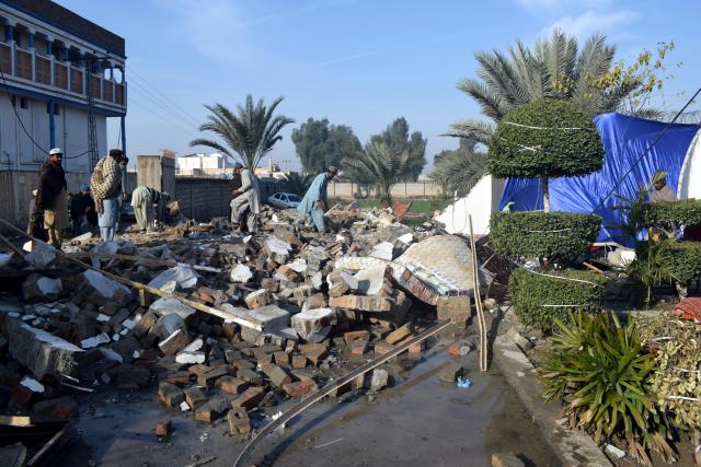 (260124) -- DERA ISMAIL KHAN, Jan. 24, 2026 (Xinhua) -- People examine a suicide blast site in Dera Ismail Khan, Khyber Pakhtunkhwa province, Pakistan, on Jan. 24, 2026. At least five people were killed and 10 others injured in a suicide blast at a wedding ceremony in Dera Ismail Khan district of Pakistan's northwest Khyber Pakhtunkhwa province on Friday, police said. No group claimed responsibility for the attack yet. (Str/Xinhua)