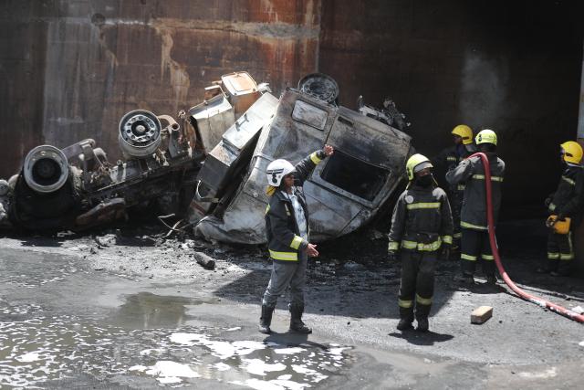(260124) -- NAIROBI, Jan. 24, 2026 (Xinhua) -- Emergency workers work at the site of an oil tanker explosion in Nairobi, the capital of Kenya, Jan. 24, 2026. At least one person killed after an oil tanker collided with a truck and exploded on a road near Wilson Airport in Nairobi, Kenya, local media reported. (Photo by Henry Naminde/Xinhua)
