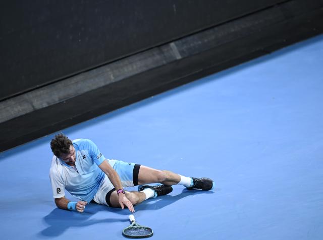 (260124) -- MELBOURNE, Jan. 24, 2026 (Xinhua) -- Stan Wawrinka falls down during the men's singles 3rd round match between Taylor Fritz of the United States and Stan Wawrinka of Switzerland at the Australian Open tennis tournament in Melbourne, Australia, Jan. 24, 2026. (Photo by Wang Shen/Xinhua)