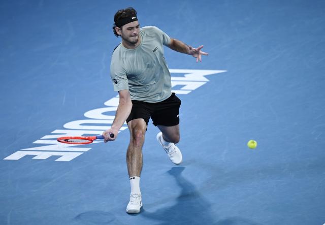 (260124) -- MELBOURNE, Jan. 24, 2026 (Xinhua) -- Taylor Fritz hits a return during the men's singles 3rd round match between Taylor Fritz of the United States and Stan Wawrinka of Switzerland at the Australian Open tennis tournament in Melbourne, Australia, Jan. 24, 2026. (Photo by Wang Shen/Xinhua)