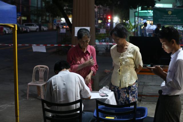 (260125) -- YANGON, Jan. 25, 2026 (Xinhua) -- Voters check their information at a polling station in Yangon, Myanmar, Jan. 25, 2026. The final phase of Myanmar's multi-party democratic general election began on Sunday morning, with polling stations opening in about 60 townships. (Xinhua/Myo Kyaw Soe)