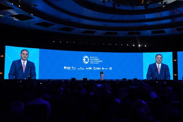 (260125) -- TRIPOLI, Jan. 25, 2026 (Xinhua) -- Libyan Prime Minister Abdul-Hamid Dbeibah delivers a speech during the fourth edition of the Libya Energy & Economic Summit in Tripoli, Libya, Jan. 24, 2026. Libyan Prime Minister Abdul-Hamid Dbeibah announced on Saturday the signing of an oil agreement with two foreign companies, with the investments exceeding 20 billion U.S. dollars.
   In a post published on his official Facebook page, Dbeibah said that Libya signed a development agreement for a period of 25 years with TotalEnergies of France and the U.S. company ConocoPhillips.
   The signing of the agreements and memoranda took place on the sidelines of the fourth edition of the Libya Energy & Economic Summit, which kicked off on Saturday in the capital Tripoli, with participation from international and Libyan companies. (Photo by Hazem Turkia/Xinhua)