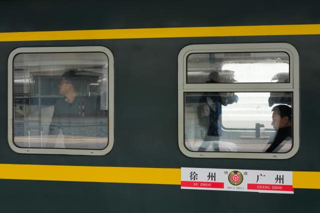 (260125) -- GUANGZHOU, Jan. 25, 2026 (Xinhua) -- Passengers are seen on train K303 at Guangzhou Railway Station in Guangzhou, south China's Guangdong Province, Jan. 25, 2026. Train K303, the last conventional train departed here on Sunday, concluding the terminal operation of this kind of trains at the century-old station. (Xinhua/Wu Lu)