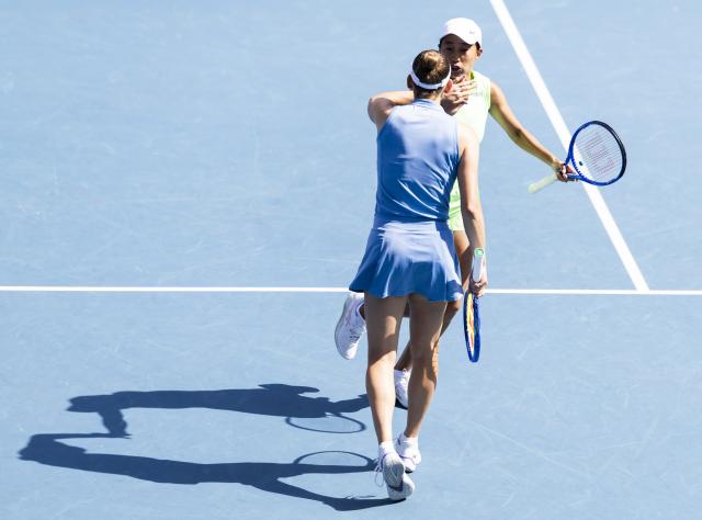 (260125) -- MELBOURNE, Jan. 25, 2026 (Xinhua) -- Elise Mertens/Zhang Shuai (back) celebrate scoring during the women's doubles 2nd round match between Elise Mertens (Belgium)/Zhang Shuai (China) and Iva Jovic (the United States)/Victoria Mboko (Canada) at the Australian Open tennis tournament in Melbourne, Australia, Jan. 25, 2026. (Photo by Hu Jingchen/Xinhua)