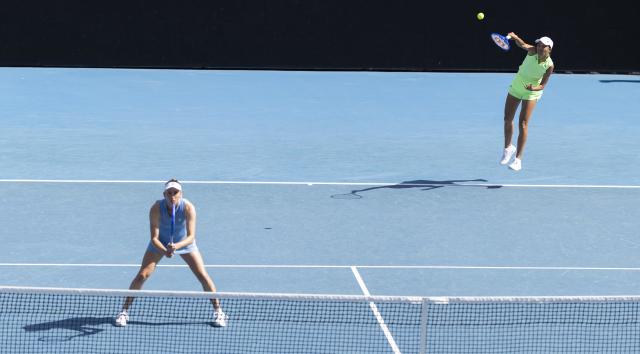 (260125) -- MELBOURNE, Jan. 25, 2026 (Xinhua) -- Elise Mertens/Zhang Shuai (R) compete during the women's doubles 2nd round match between Elise Mertens (Belgium)/Zhang Shuai (China) and Iva Jovic (the United States)/Victoria Mboko (Canada) at the Australian Open tennis tournament in Melbourne, Australia, Jan. 25, 2026. (Photo by Hu Jingchen/Xinhua)