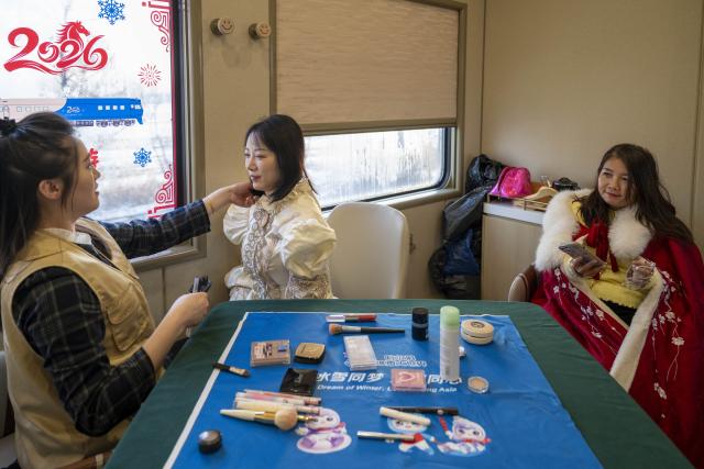 (260125) -- HARBIN, Jan. 25, 2026 (Xinhua) -- A passenger is made up on the Train Y783 in northeast China's Heilongjiang Province, Jan. 25, 2026. Train Y783, a themed tourism train bound for Yabuli featuring travel photography services, was inaugurated Sunday in Harbin. It marks the company's first offering of its kind this year. Operated by China Railway Harbin Group Co., Ltd., the train allows passengers to dress in diverse costumes and avail themselves of photography services. (Xinhua/Zhang Tao)