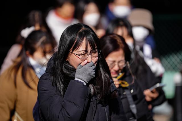 (260125) -- TOKYO, Jan. 25, 2026 (Xinhua) -- Visitors grief after bidding farewell to giant pandas at Ueno Zoo in Tokyo, Japan, Jan. 25, 2026. Giant pandas Xiao Xiao and Lei Lei, currently residing at a zoo in Tokyo, will depart for China on Jan. 27, marking the first time in about half a century that Japan will be without any pandas, local media reported. (Xinhua/Jia Haocheng)