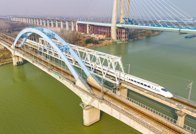 (260125) -- BEIJING, Jan. 25, 2026 (Xinhua) -- A drone photo taken on Jan. 25, 2026 shows a bullet train running on a section of the Ningxia-Qidong Railway in Yangzhou, east China's Jiangsu Province. A new train schedule will be put into effect in China from Jan. 26. 2026. (Photo by Ren Fei/Xinhua)