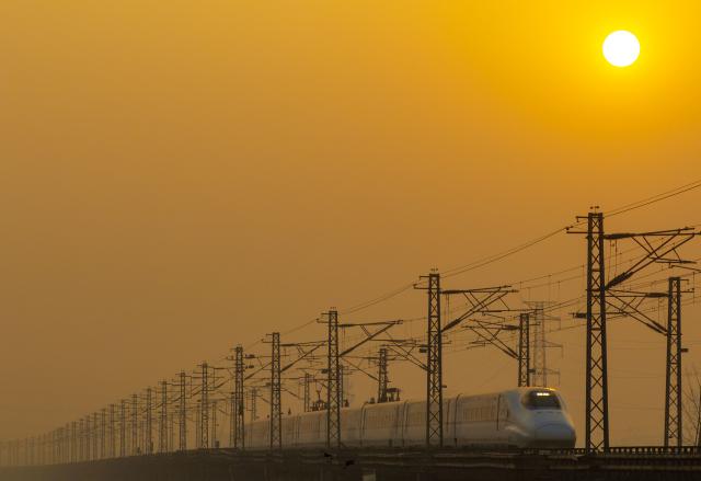 (260125) -- BEIJING, Jan. 25, 2026 (Xinhua) -- A drone photo taken on Jan. 25, 2026 shows a train running in Taizhou City of east China's Jiangsu Province. A new train schedule will be put into effect in China from Jan. 26. 2026. (Photo by Tang Dehong/Xinhua)