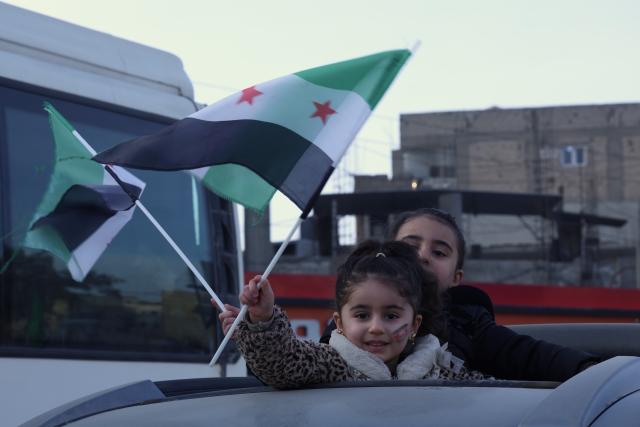 (260126) -- BEIJING, Jan. 26, 2026 (Xinhua) -- Children wave flags in Raqqa, northern Syria, Jan. 21, 2026. (Str/Xinhua)