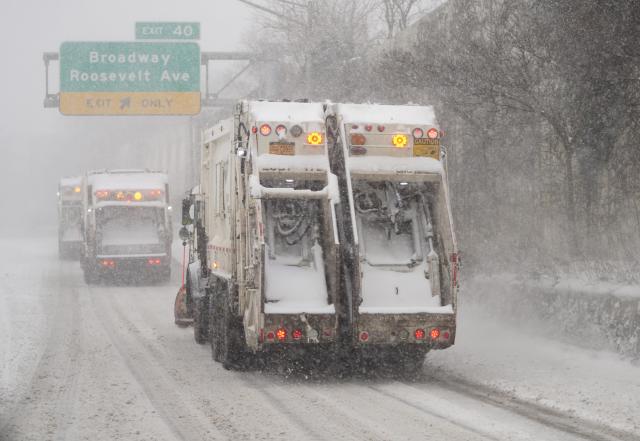 (260126) -- NEW YORK, Jan. 26, 2026 (Xinhua) -- Snowplows are pictured on a snow-covered road in New York, the United States, on Jan. 25, 2026. A historic winter storm is sweeping across the Midwest and eastern parts of the United States on Sunday, causing unprecedented travel chaos. (Xinhua/Zhang Fengguo)