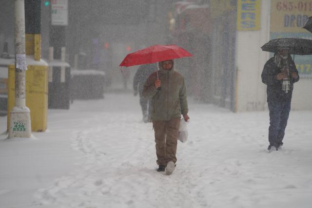 (260126) -- NEW YORK, Jan. 26, 2026 (Xinhua) -- People walk on a street amid snow in New York, the United States, on Jan. 25, 2026. A historic winter storm is sweeping across the Midwest and eastern parts of the United States on Sunday, causing unprecedented travel chaos. (Xinhua/Zhang Fengguo)